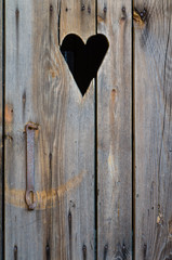 wooden restroom door wih heart shape