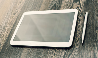 digital tablet on wooden table