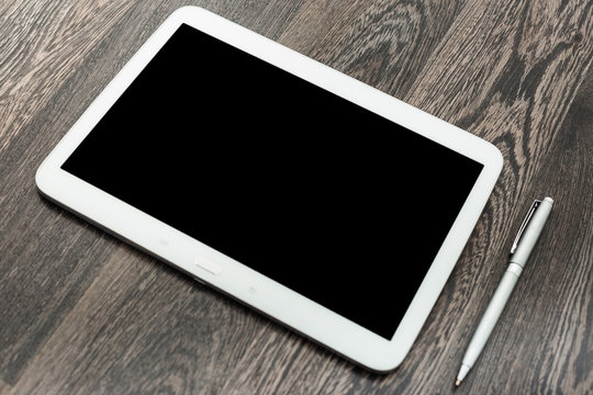 digital tablet on wooden table
