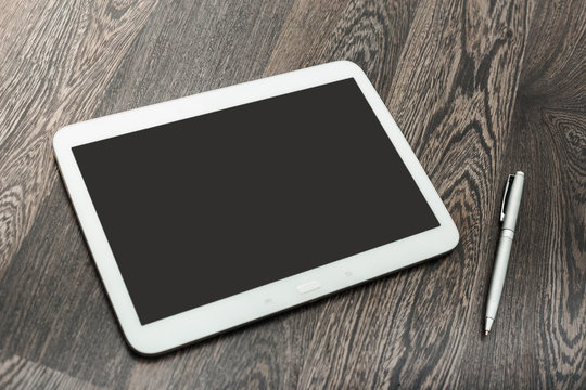digital tablet on wooden table