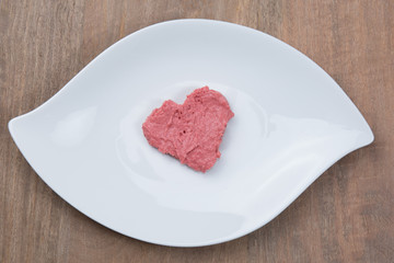 Closeup of a plate with heart-shaped strawberry jam