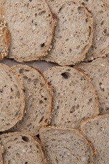 Brown slices of bread isolated over wooden brown  background