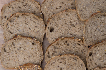 Brown slices of bread isolated over wooden brown  background