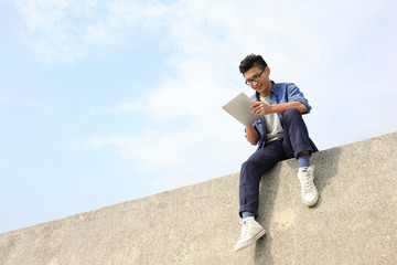 Happy man using digital tablet