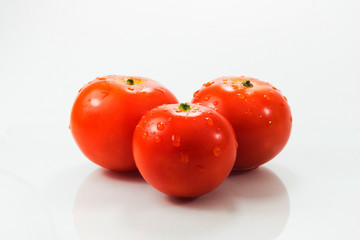 Three tomatoes isolated on white background
