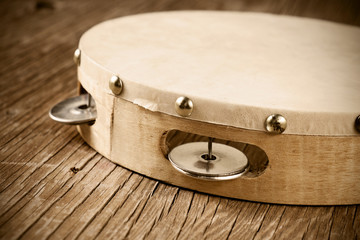 tambourine on a rustic wooden table, retro look