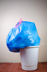 overcrowded bag of rubbish in basket - 82064230