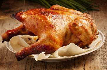 baked chicken on a plate with pita bread