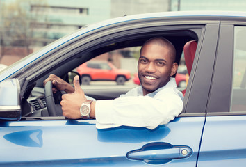 Man happy smiling showing thumbs up driving sport blue car