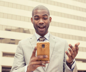 surprised handsome young man looking at phone
