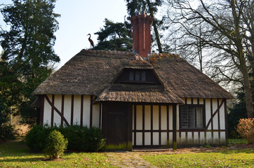 cute little servants house with reed roof in park Den Brandt