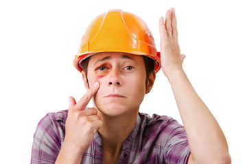 Female worker with a black eye in the helmet