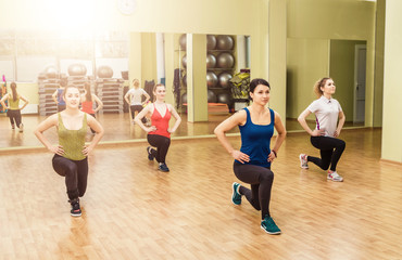 Fototapeta premium Group of women making step aerobics