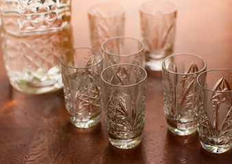 Shot glasses of vodka on a wooden table, addiction to alcohol