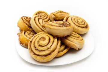 Tasty homemade fresh cinnamon rolls on a plate isolated