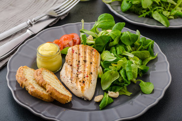 Grilled chicken with salad and nuts