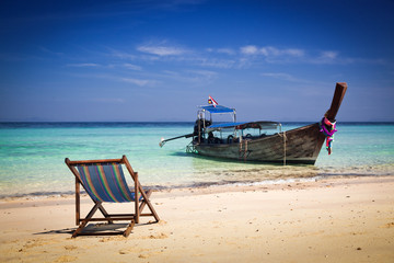 Exotic beach holiday background with beach chair and long tail b