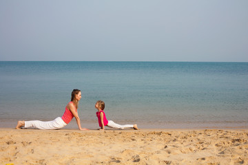 Mother and daughter doing yoga exercise