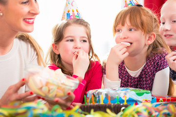 Kinder auf Party naschen Süßigkeiten