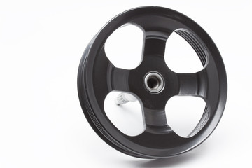 Obraz premium Black pulley car engine on a gray background