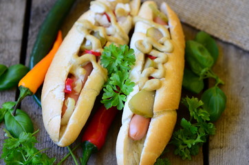 Delicious Chicago style hot dog with chilli on wood background
