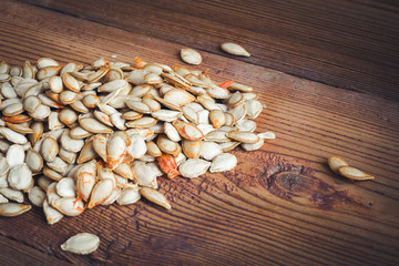 pumpkin seeds on wood background