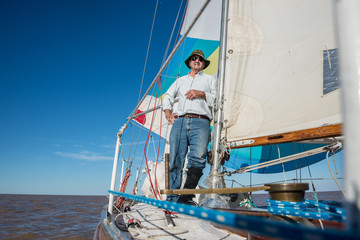 Senior retired sailing Buenos Aires River to Uruguay. Sport free