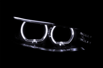 LED headlights of car on black background. Exterior detail.