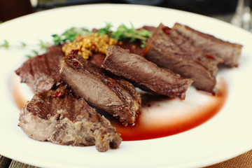 Steak on plate on table close up