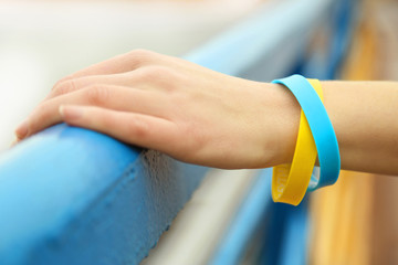 Hand with blue-yellow bracelet - colors of flag of Ukraine