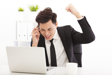 happy businessman talking on the phone in  office