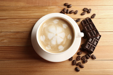Cup of coffee latte art with grains and chocolate bar