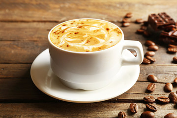 Cup of coffee latte art with grains and chocolate