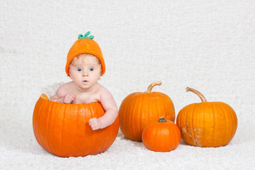 Baby in Pumpkin Hat Inside Pumpkin