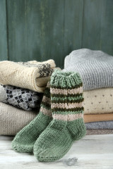 Knitting clothes on wooden background