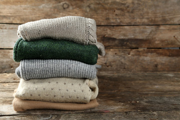 Knitting clothes on wooden background