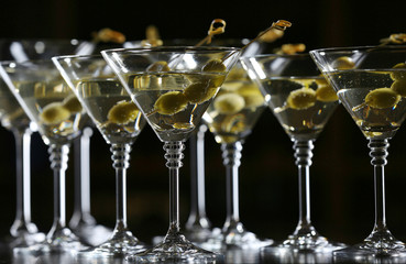 Glasses of cocktails on bar background