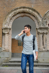 Fototapeta na wymiar Asian college student standing at college