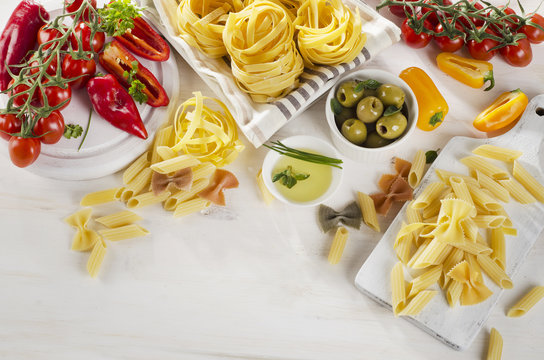 Healthy Italian food ingredients on a whiete wooden background.