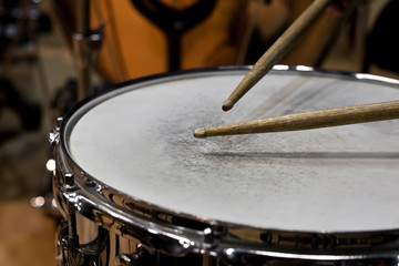 Fototapeta na wymiar Drum sticks hitting the drum closeup