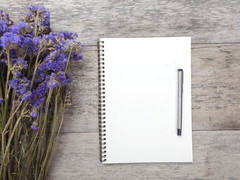 note book on wooden background