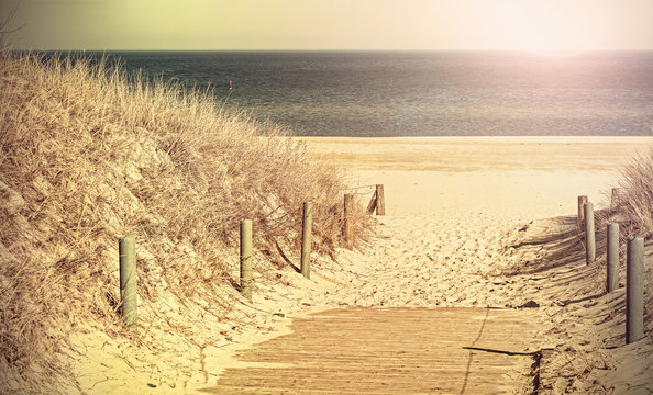 Retro toned photo of a beach path.