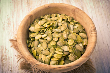 Pumpkin seeds in a wood bowl