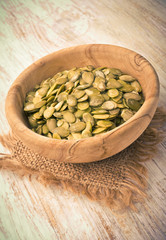 Pumpkin seeds in a wood bowl