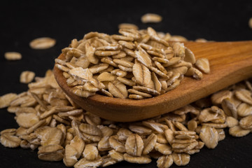 oat flakes on a wooden spoon