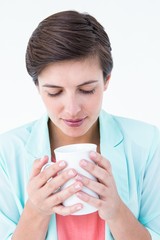 Casual brunette drinking coffee