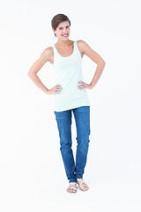 Obraz premium Happy woman smiling at camera with hands on hip