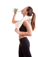 Woman after sport drinking water from bottle