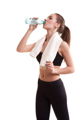 Woman after sport drinking water from bottle