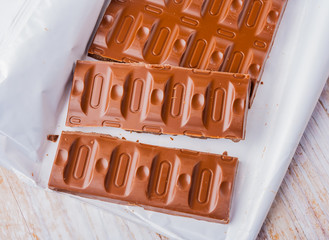 chocolate pieces on white wooden table